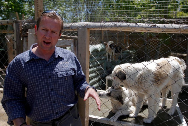 Pen Farthing, founder of British charity Nowzad, an animal shelter, stands in front of a cage on the...