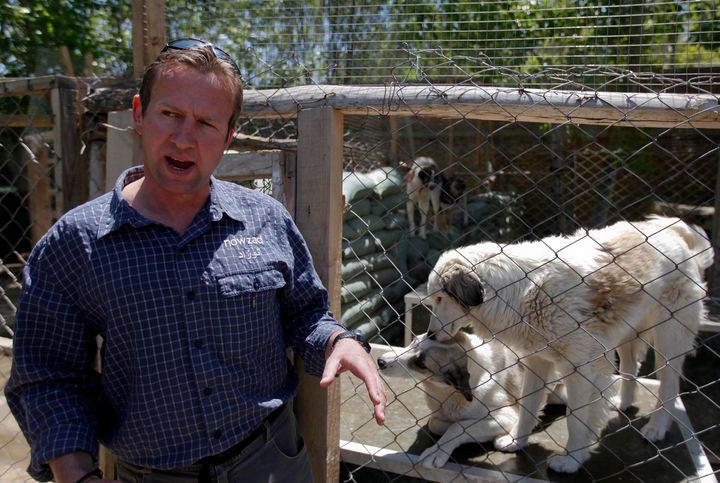 Pen Farthing, founder of British charity Nowzad, an animal shelter, stands in front of a cage on the outskirts of Kabul May 1, 2012