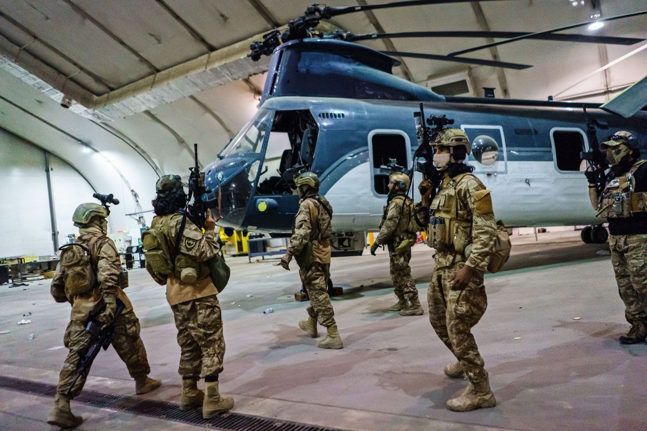 Taliban fighters from the Fateh Zwak unit wielding American supplied weapons, equipment and uniforms, storm into Kabul airport to secure the airport and inspect the equipment that was left behind.