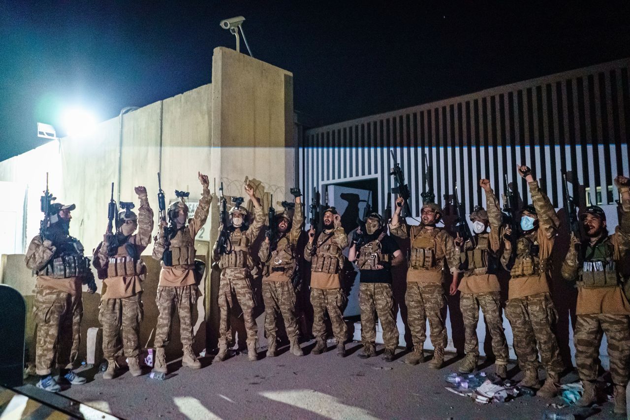 Taliban fighters from the Fateh Zwak unit celebrate before storming into the Kabul International Airport, wielding American supplied weapons, equipment and uniforms after the United States Military have completed their withdrawal, in Kabul, Afghanistan.
