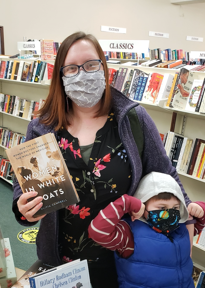 The author with her son and her book, "The Women in White Coats," at a local independent bookstore, March 2021.