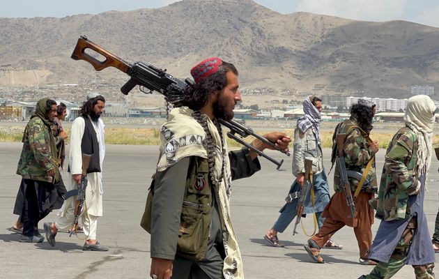 Taliban forces patrol at a runway a day after US troops withdraw from Hamid Karzai International Airport...