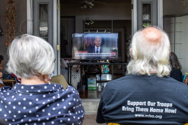 A group of military families and veterans, including a post-9/11 veteran who served in Afghanistan and the mother of a Marine who left the Kabul airport last week, gather in a Long Beach, California, home to watch President Joe Biden's speech Tuesday.