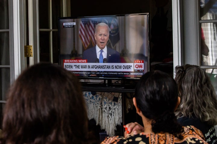 Military families and veterans watch President Joe Biden's speech announcing that all troops are out of Afghanistan on Aug. 3