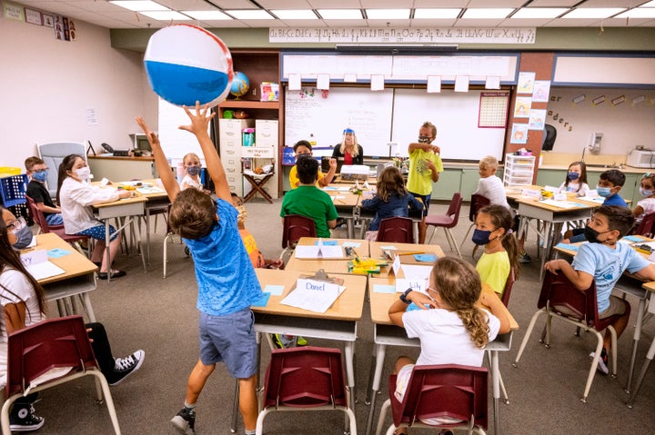 Students pass a beach ball to the next person on the list during roll call on the first day of class at Laguna Niguel Elementary School in Laguna Niguel, California, on Aug. 17.