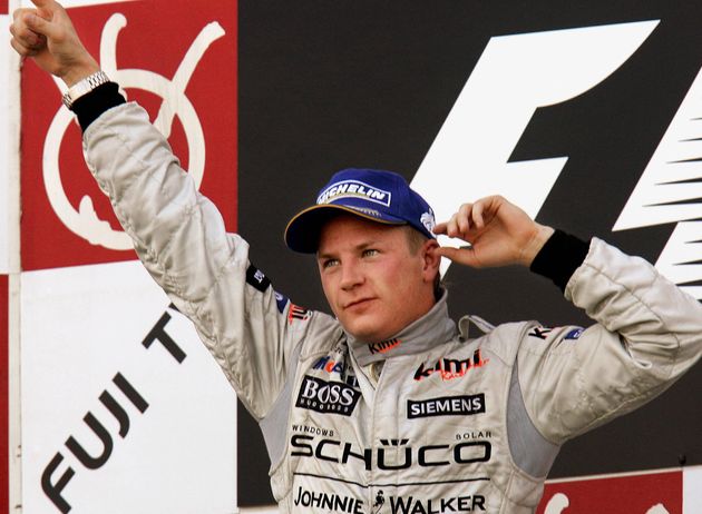 鈴鹿サーキットで行われたF1日本GPで16台抜きで優勝し、表彰台で腕を振り上げるキミ・ライコネン選手。（2005年10月9日撮影）