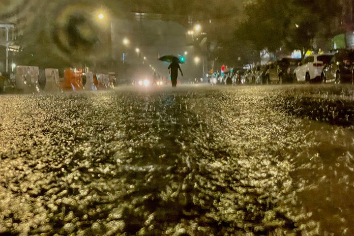 A person makes their way in rainfall from the remnants of Hurricane Ida on Wednesday in the Bronx borough of New York City.