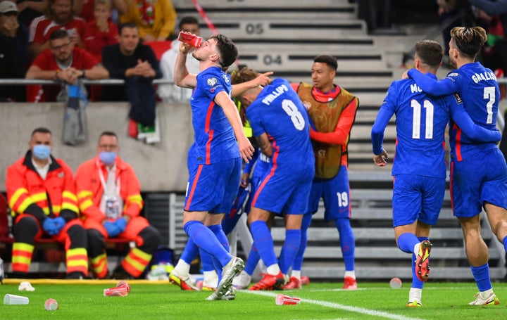 Declan Rice drinks from a cup that was thrown at Raheem Sterling after scoring their first goal.