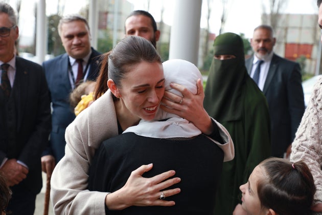 Jacinda Ardern consoling a grieving woman after the 2019