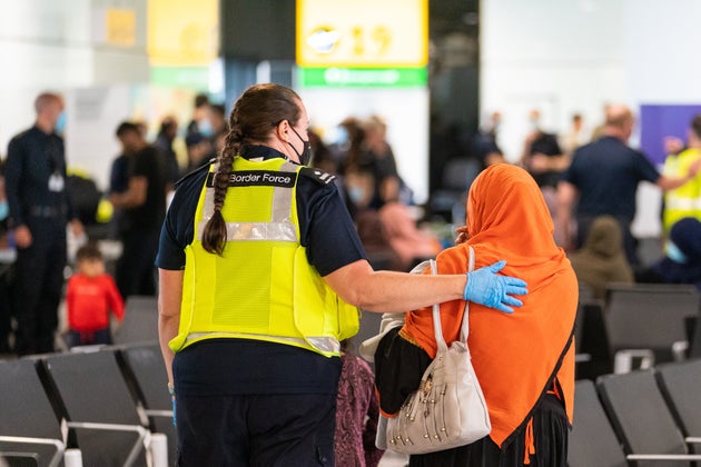 Afghan evacuees arriving at Heathrow Airport in