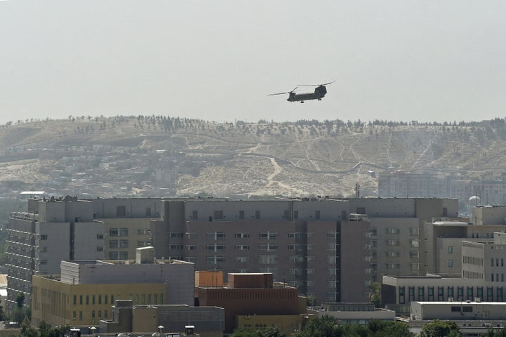 A U.S. Chinook military helicopter flies above the U.S. Embassy in Kabul on Aug. 15, 2021.