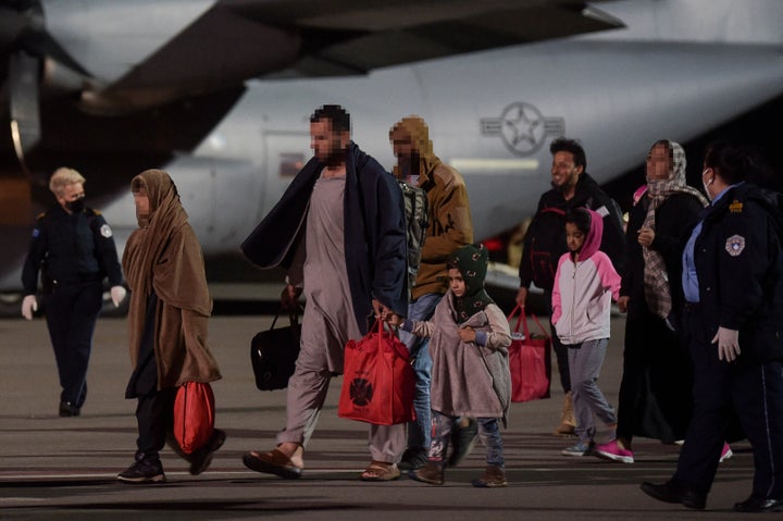 Afghan refugees exit a U.S. Air Force plane at Pristina International airport near Pristina, Kosovo, on Aug. 29, 2021.