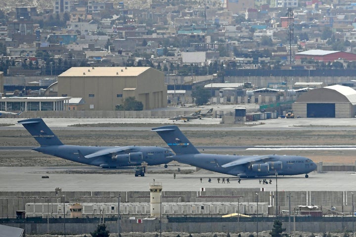 U.S. soldiers walk to board aircraft at the airport in Kabul on Aug. 30.&nbsp;