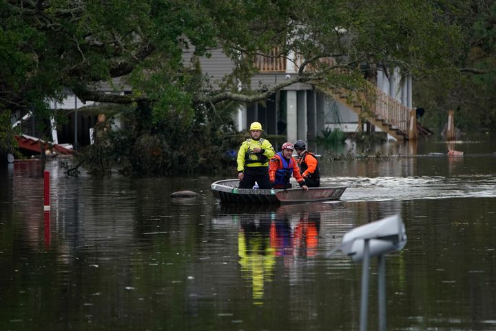 People conducting an animal rescue operation drive a boat down a flooded street in the aftermath of Hurricane Ida, Wednesday, Sept. 1, 2021, in Lafitte, Louisiana.