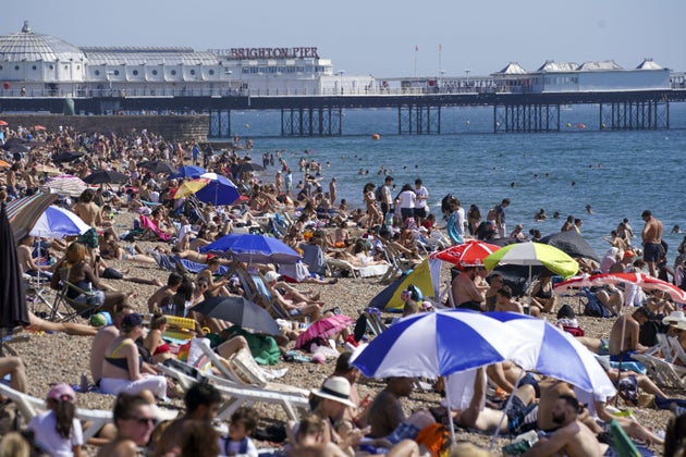 People enjoy the warm weather at Brighton beach in West