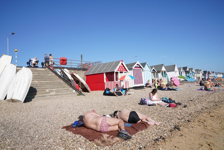 People enjoy the warm weather on the beach at South End on Sea, Essex.