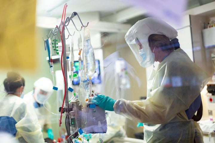 Nurse Jack Kingsley attends to a COVID-19 patient in the intensive care unit at St. Luke's Boise Medical Center in Boise, Ida