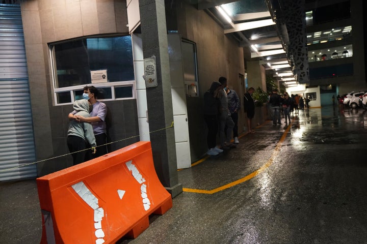 People gather outside a building after a strong earthquake was felt in Mexico City on Tuesday.