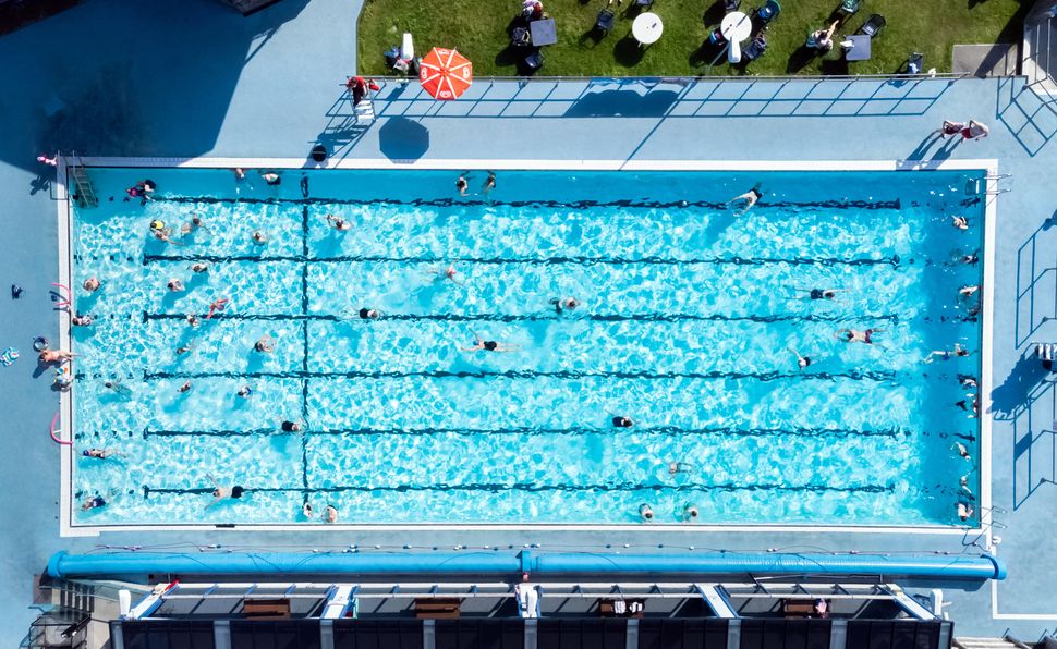 People enjoy the hot weather at Hathersage Swimming Pool in the Hope Valley, Peak District. 