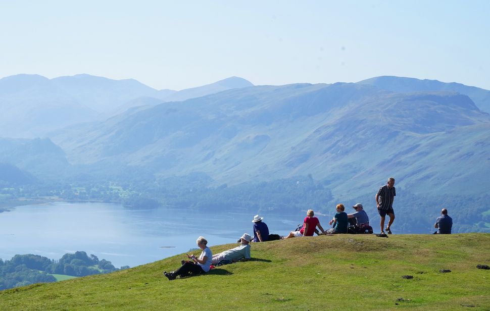 Walkers take in the view of Derwent Water in Cumbria. 