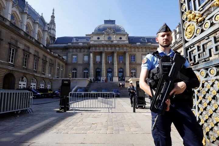 French police stand guard in front of the courthouse on the Ile de la Cite ahead of the opening of the trial of the 2015 Paris attacks.