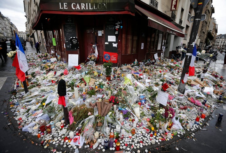 This 2015 file photo shows some of the flowers and candle tributes that were placed at the Restaurant Le Carillon in Paris, after the attacks.