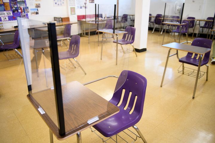 Plexiglass dividers surround desks as students return to in-person learning at a school in Long Beach, California, on March 24. Pediatric COVID-19 cases had dropped at the start of summer but are now again rising.