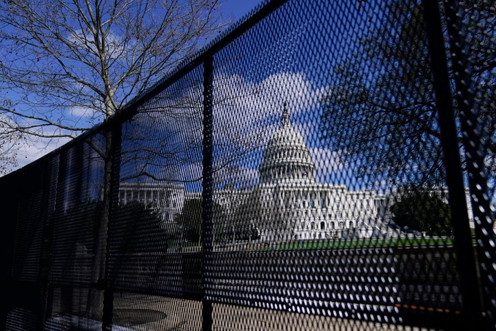 In this April 2, 2021, file photo, the U.S. Capitol is seen behind security fencing on Capitol Hill in Washington. Law enforcement concerned by the prospect for violence at a rally in the nation’s Capitol next week are planning to reinstall protective fencing that surrounded the U.S. Capitol for months after the Jan. 6 insurrection there, according to a person familiar with the discussions.