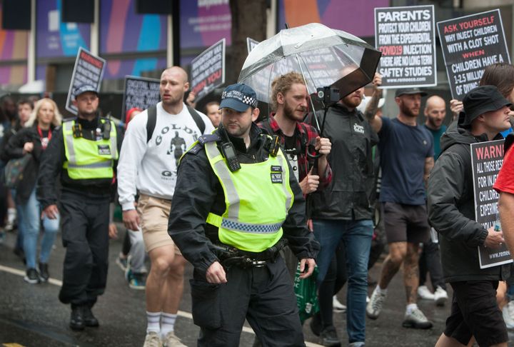 Police monitoring a UK anti-vaccine protest in August
