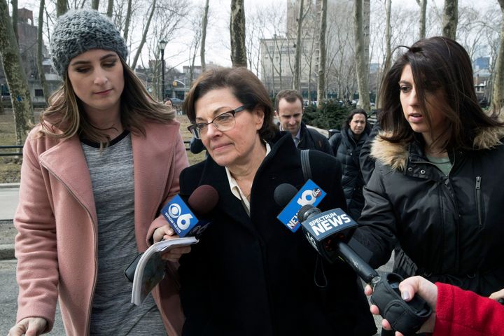 Nancy Salzman, center, is surrounded by reporters as she arrives at Brooklyn federal court, Wednesday, March 13, 2019, in New York. Salzman, a co-founder of NXIVM, an embattled upstate New York self-help organization, is expected to plead guilty in a case featuring sensational claims that some followers became branded sex slaves. (AP Photo/Mary Altaffer)