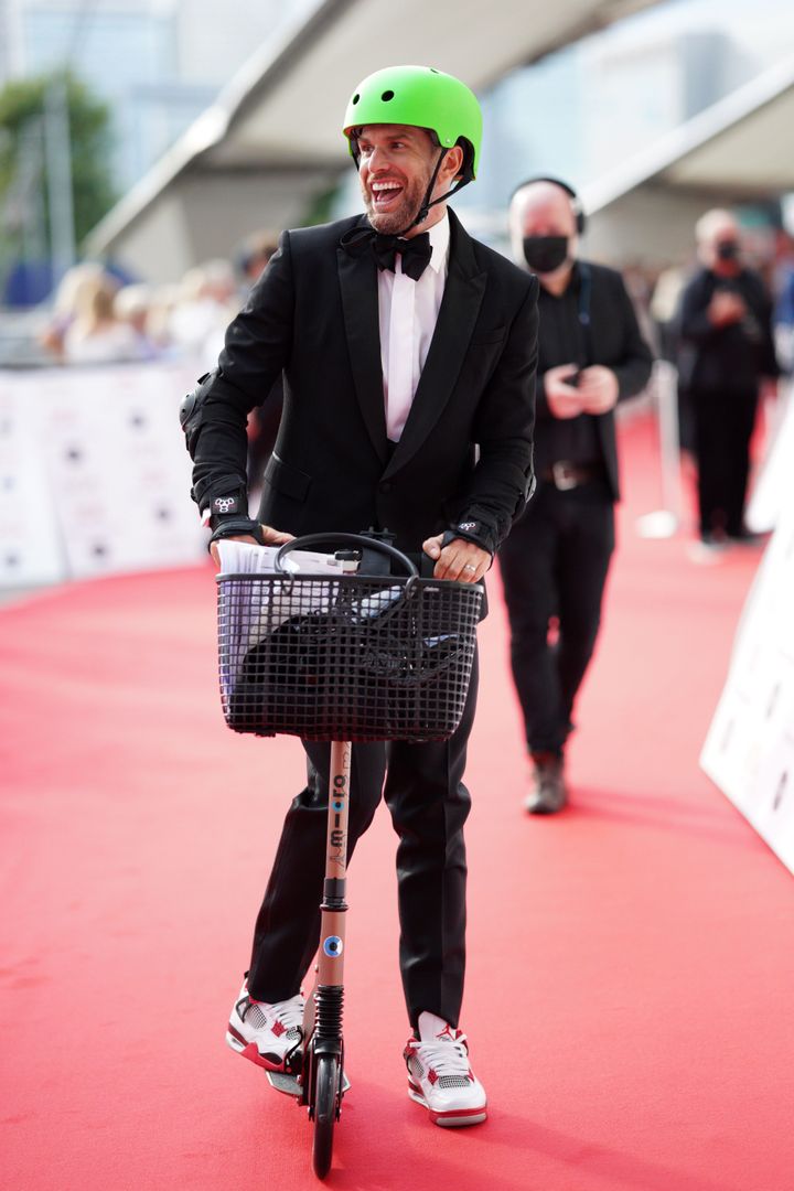 Joel looked somewhat more comfortable on the scooter as he made it further down the red carpet