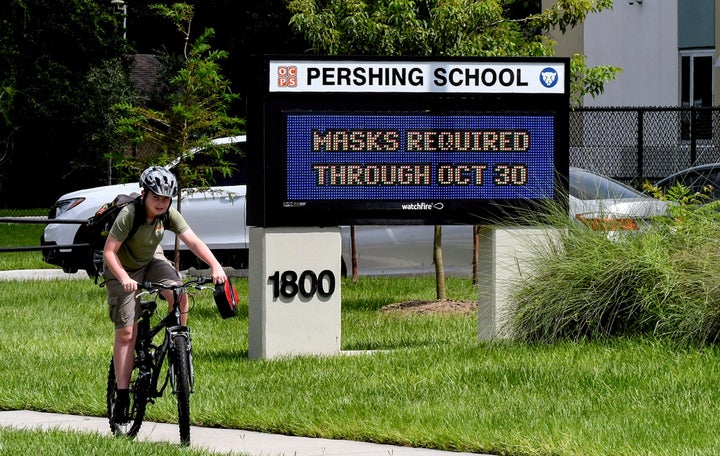 A sign at Pershing School in Orlando advises that face masks are required for students through Oct. 30. On Aug. 27, a Florida