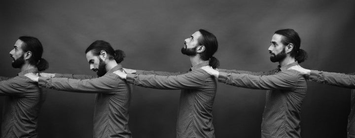 repetition of self: multiple copies (doubles) of a man queuing with the arms stretched onto his own shoulders