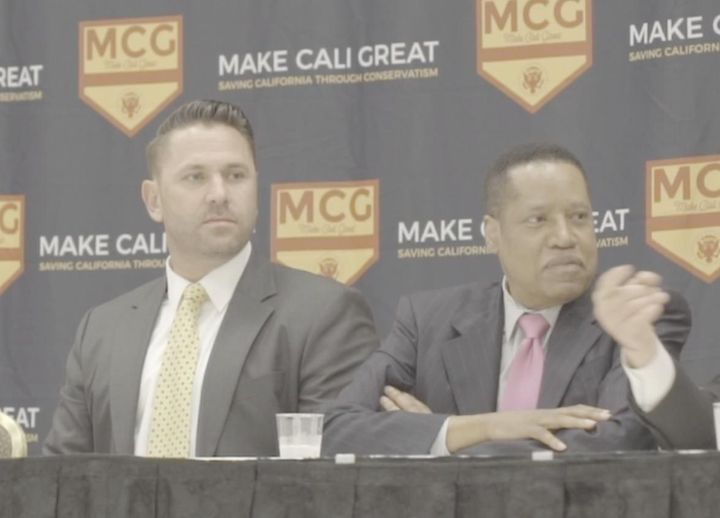 Larry Elder (right) sits next to Kyle Chapman, a white nationalist, during a panel discussion at the "Summer of Conservatism" conference in Anaheim, California, in July 2017.