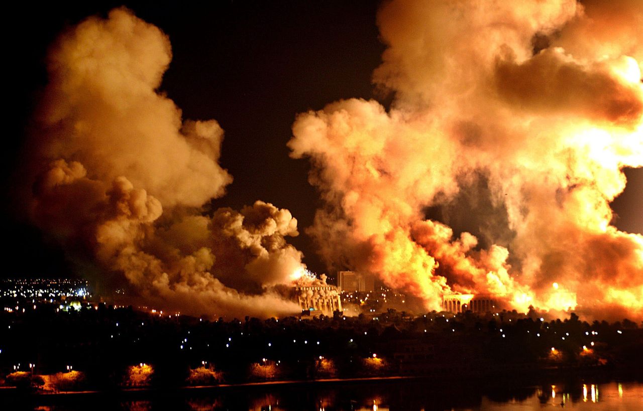 Fires rage on the west bank of the Tigris River on March 21, 2003, in Baghdad during the U.S. "Shock and Awe" bombing campaign commenced in Iraq.