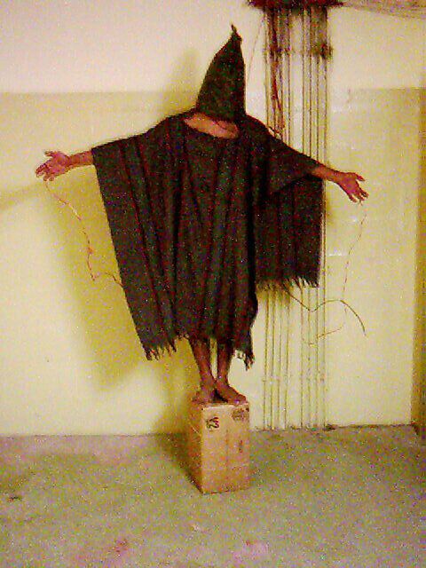 An unidentified detainee is forced to stand on a box with a bag over his head and wires attached to him in late 2003 at the Abu Ghraib prison in Baghdad.