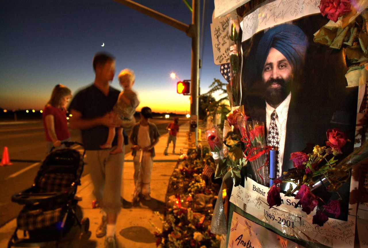 Visitors paid tribute at a memorial for Balbir Singh Sodhi at the Arizona gas station where he was murdered on Sept. 15, 2001. Sodhi was popular in the neighborhood and often gave candy to children.