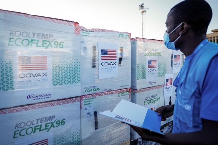 A UNICEF worker checks boxes of Moderna coronavirus vaccine after their arrival in Nairobi on Aug. 23 — the first time the Moderna drug has been received in Kenya.