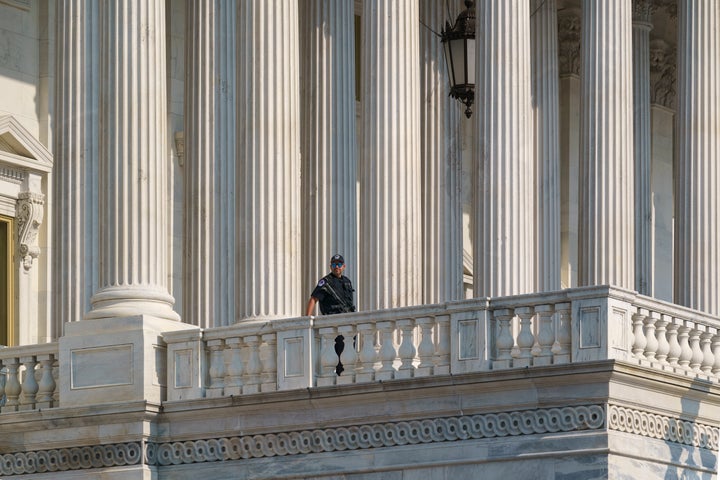A U.S. Capitol Police officer keeps watch at the House of Representatives in July. More than 100 police officers were in
