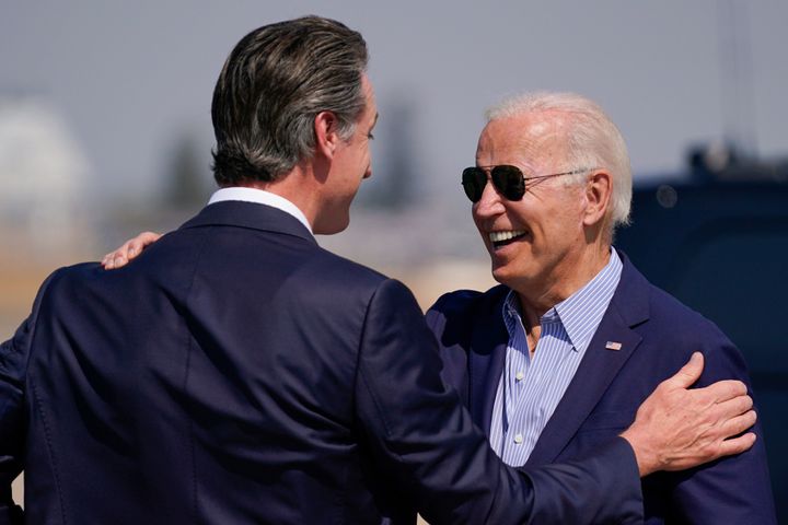President Joe Biden talks with California Gov. Gavin Newsom as he arrives Monday at Mather Airport on Air Force One in Mather, California, for a briefing on wildfires in the state.