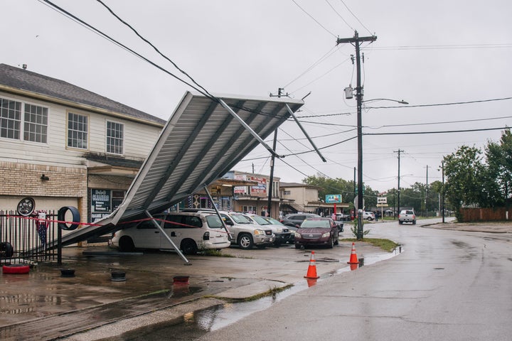 A carport hangs from power-lines after Tropical Storm Nicholas moved through the area Tuesday in Houston, Texas.