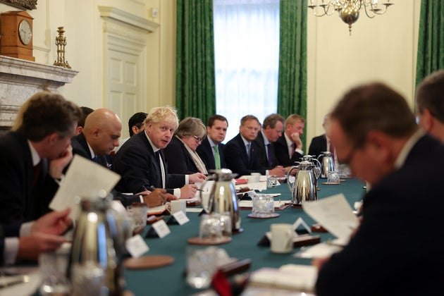 Between 30 and 40 ministers crowded together for a cabinet minister in this photograph, released on