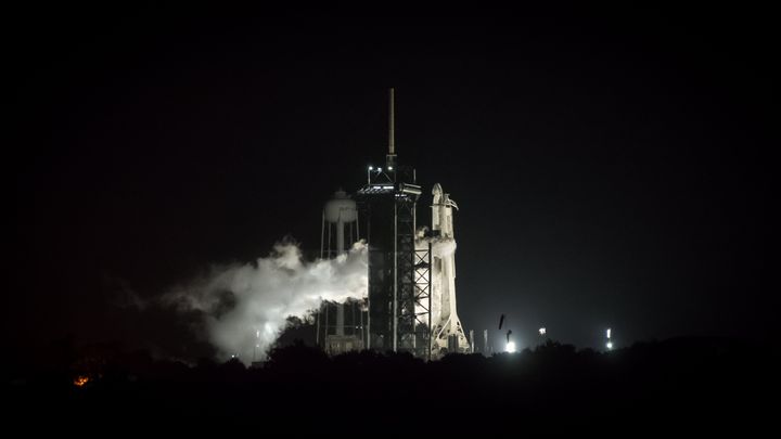 A Falcon 9 Rocket stands on the launch pad at Kennedy Space Center in the predawn hours of August 29, 2021. (Photo by George 