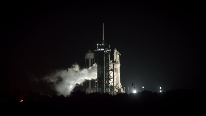 A Falcon 9 Rocket stands on the launch pad at Kennedy Space Center in the predawn hours of August 29, 2021. (Photo by George