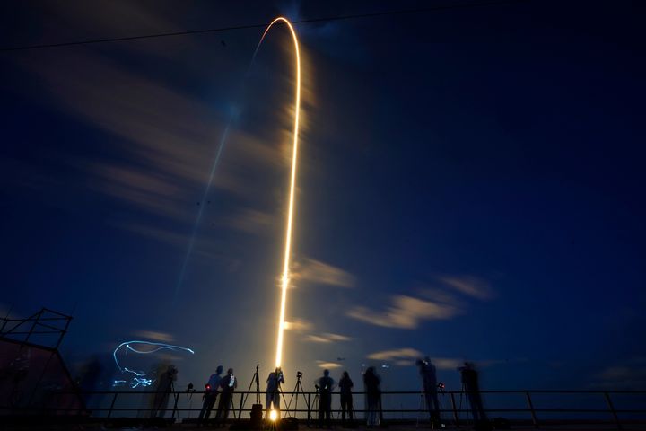 A SpaceX Falcon 9 rocket, with four private citizens onboard, lifts off in this time-exposure photo from Kennedy Space Center