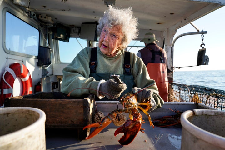 Virginia Oliver, age 101, works as a sternman, measuring and banding lobsters on her son Max Oliver's boat, Tuesday, Aug. 31, 2021, off Rockland, Maine. The state's oldest lobster harvester has been doing it since before the onset of the Great Depression. (AP Photo/Robert F. Bukaty)