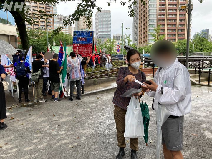 都内で行われたデモの現場で、チラシを配布して呼びかけるNHK取材班