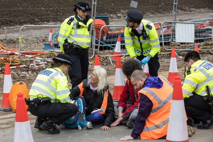 Insulate Britain climate activists pictured glued onto a slip road from the M25
