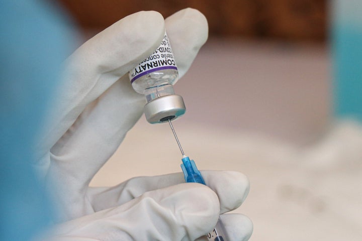 A health worker extract the Pfizer COVID-19 vaccine form a vial. The company announced Monday that its COVID-19 vaccine works for children ages 5 to 11 following trials.