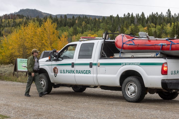 A park ranger speaks with a colleague on the road to Spread Creek Campground on Sunday near Moran, Wyoming. Law enforcement s